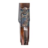 A Merkel side-by-side double rifle with Meopta scope and interchangeable side-by-side shotgun barrel