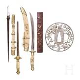 A Tsuba, a Kozuka, an arrowhead and two miniature swords, Japan, Edo period
