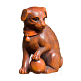 A Japanese netsuke, a dog with a ball, 19th century