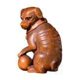 A Japanese netsuke, a dog with a ball, 19th century