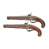 A fine pair of southern German percussion pistols with chiseled mounts, circa 1780