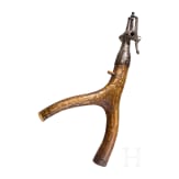 A carved Transylvanian powder flask with wheel-lock spanner, 17th/early 18th century