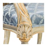 A carved Swedish/Scandinavian neoclassical fauteuil, painted white and partly gilded, early 19th century