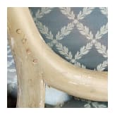 A carved Swedish/Scandinavian neoclassical fauteuil, painted white and partly gilded, early 19th century