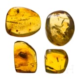 Four amber stones with inclusions