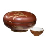A round lacquer box and a porcelain tea bowl, Japan, Meiji-Period and China, respectively
