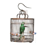 A large Chinese songbird cage, circa 1900, with shells and fayance sculpture of an ara