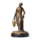 A bronze figure of a nymph fetching water, signed "J.G. Rau"