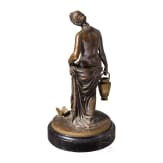 A bronze figure of a nymph fetching water, signed "J.G. Rau"