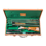 A cased double-barrelled over-and-under rifle by Hambrusch with three extra barrels