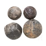 Four German cast iron cannon balls, 16th century