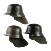 Three fire helmets with shoulder boards, 1950s - 1970s