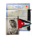 A large photo of King Hussein I, a vehicle standard, a map