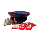 A visor cap and assorted insignia