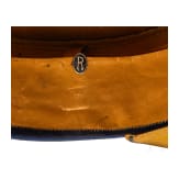 A visor cap and assorted insignia
