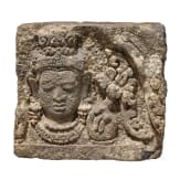 A Javanese relief stone with the head of Bodhisattva, 9th century