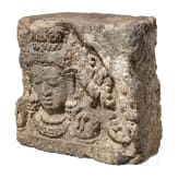 A Javanese relief stone with the head of Bodhisattva, 9th century