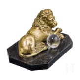 A South German reclining bronze lion with orb, probably circa 1900