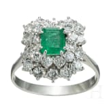 An emerald and diamond white gold ring