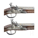 A magnificent pair of German chiselled flintlock pistols, circa 1780