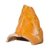 An orange-glazed front of a Thai roof tile (end of a monk tile) decorated with a temple guardian, circa 1900