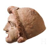 A Hellenistic terracotta theatre mask of the New Comedy, naive Ephebe type, 2nd century B.C.
