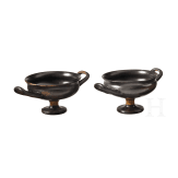 Two Greek bowls with handles made of black-glazed pottery, 4th century B.C.