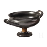 Two Greek bowls with handles made of black-glazed pottery, 4th century B.C.