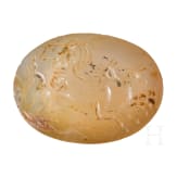 A Greek agate stone gem with Poseidon in biga drawn by two hippokamps, 4th century B.C.