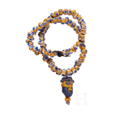 A modern-stringed necklace of 69 eye beads and a Phoenician face bead, early Celtic, partly Mediterranean, 5th - 4th century B.C.