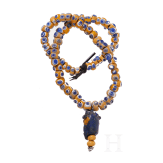 A modern-stringed necklace of 69 eye beads and a Phoenician face bead, early Celtic, partly Mediterranean, 5th - 4th century B.C.