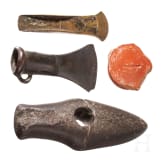 A stone axe, a flanged axe and a socketed axe, Copper Age and Bronze Age, mid-3rd millennium to 8th century B.C., plus a terra sigillata base with stamp