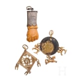 A Roman amber fig hand, 1st - 3rd century, in 19th century setting, and two amulets, 19th century