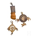 A Roman amber fig hand, 1st - 3rd century, in 19th century setting, and two amulets, 19th century