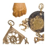 A Roman amber fig hand, 1st - 3rd century, in 19th century setting, and two amulets, 19th century