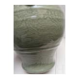 A Chinese molded Longquan celadon jar, probably Yuan Dynasty