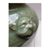 A Chinese molded Longquan celadon jar, probably Yuan Dynasty