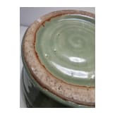 A Chinese molded Longquan celadon jar, probably Yuan Dynasty