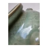 A Chinese molded Longquan celadon jar, probably Yuan Dynasty