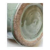 A Chinese molded Longquan celadon jar, probably Yuan Dynasty