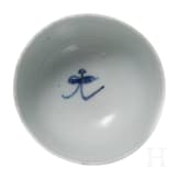 A Chinese blue and white cup and a small plate with wooden stand, Kangxi period, circa 1700