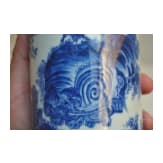 A Chinese blue and white brush pot showing a scholar in landscape, probably Kangxi period (18th century)
