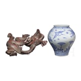 A Korean porcelain vase and a Chinese wooden dragon, 20th century