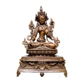 A Nepalese crystal-set bronze figurine of the Green Tara, circa 1900