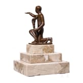 A kneeling torchbearer