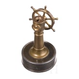 A German brass steering wheel-shaped cigar cutter, circa 1900