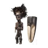 A Gabonese reliquary guardian figure and a Ngil-mask of the Fang people