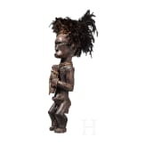 A Gabonese reliquary guardian figure and a Ngil-mask of the Fang people