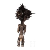 A Gabonese reliquary guardian figure and a Ngil-mask of the Fang people
