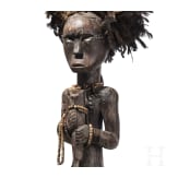 A Gabonese reliquary guardian figure and a Ngil-mask of the Fang people